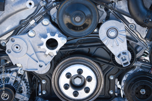 car engine detail showing belts and pulleys