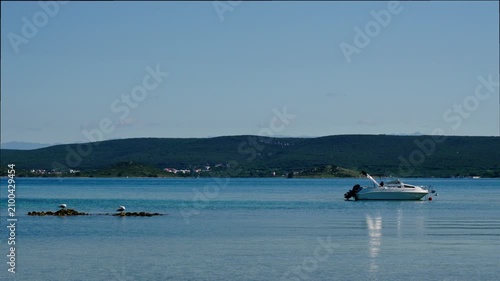 Motorboat Anchored In Calm Blue Bay