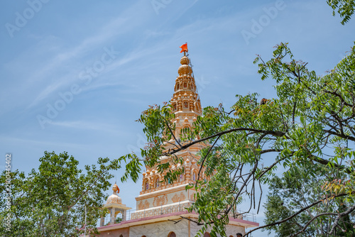Hindu Temple showcasing the beautifully carved spires (shikhara) of the Malganga Devi, located on the banks of the Kukadi River near the famous natural rock potholes in Nighoj, India.