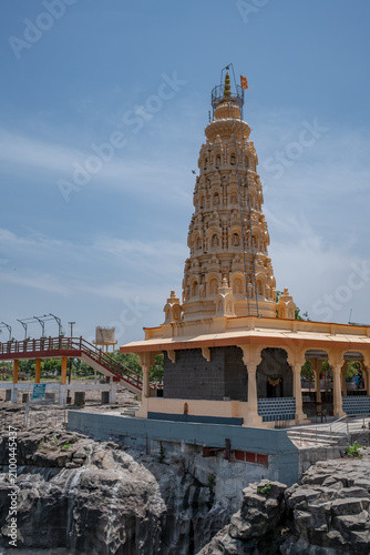 Hindu Temple showcasing the beautifully carved spires (shikhara) of the Malganga Devi, located on the banks of the Kukadi River near the famous natural rock potholes in Nighoj, India.