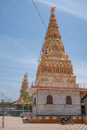 Hindu Temple showcasing the beautifully carved spires (shikhara) of the Malganga Devi, located on the banks of the Kukadi River near the famous natural rock potholes in Nighoj, India.