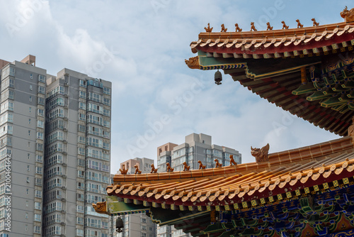 Contrast of Traditional Chinese Temple Roof with Imperial Roof Beasts and Modern High-Rise Residential Buildings in Xi'an, China