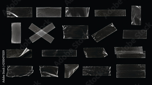 Transparent adhesive tape strips collection. Clear sticky tape pieces on black background.