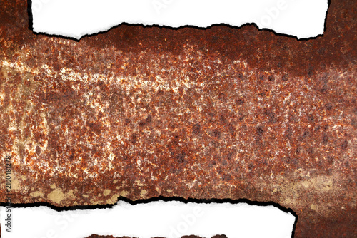 Weathered metal sheet displays heavy brown oxidation with rough jagged edges and a deep textured surface showing significant industrial decay.