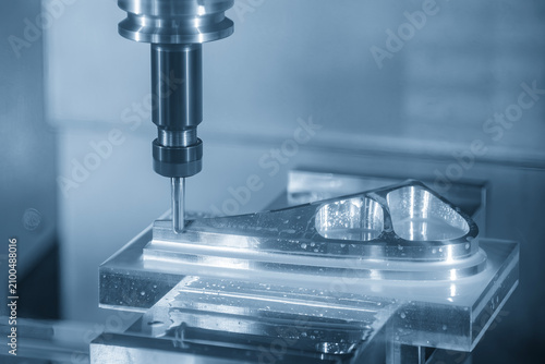 High-precision CNC milling machine performing an aerospace parts production process with a ball nose end mill tool.