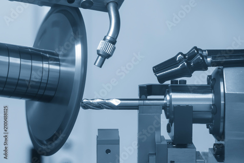 High-precision CNC grinding machine manufacturing an end mill tool with an abrasive wheel.