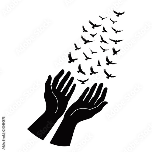 Silhouette of two human hands reaching upwards releasing a flock of birds flying into the open sky