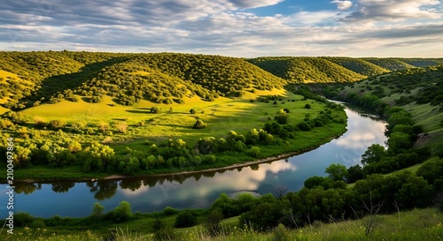 Rolling green hills and serene lake under blue sky.