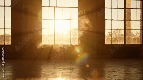 Sunlight Streaming Through Large Industrial Windows Creating Warm Atmosphere.