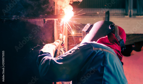 Welding steel structures and bright sparks in construction industry.
