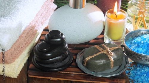 A composition of spa accessories slowly rotates around its axis. View from above.