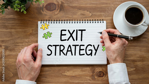 Exit Strategy Business Planning Concept with Notebook and Coffee on Office Desk