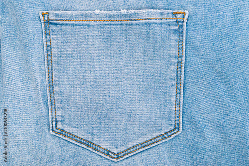 Pocket on blue jeans denim trousers close up