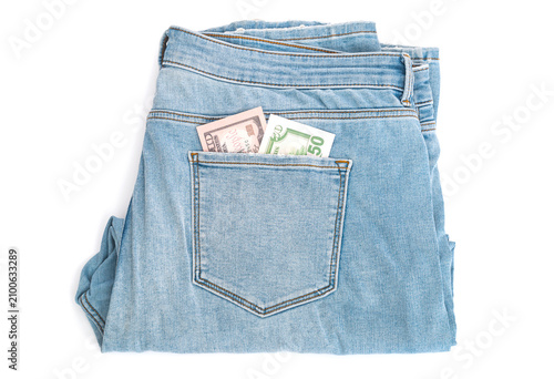 Dollars banknotes in pocket by jeans  trousers isolated on white background
