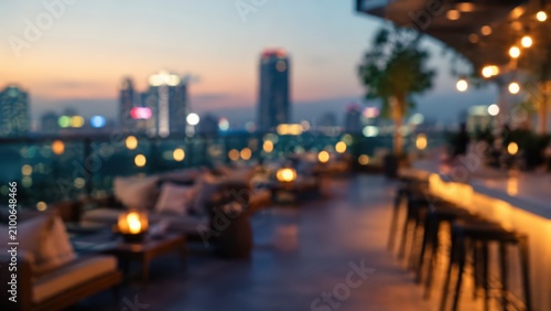 Blurred rooftop bar lounge city skyline bokeh background luxury restaurant terrace nightlife sunset urban outdoor seating cafe