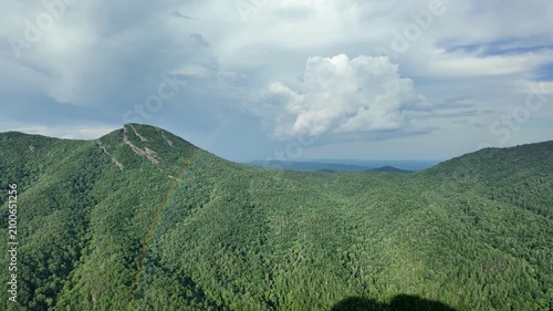 Rainbow arching over the lush Blue Ridge Mountain ridges from Wiseman's View, North Carolina, after a summer rainstorm