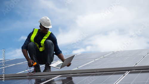 Service engineer inspecting solar panels on a roof for maintenance and damage checks, while installing clean energy technology for alternative power concepts
