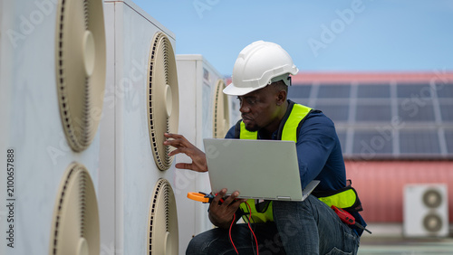 Professional engineers inspecting and checking the industrial air conditioning cooling system and HVAC units of a major facility or commercial building