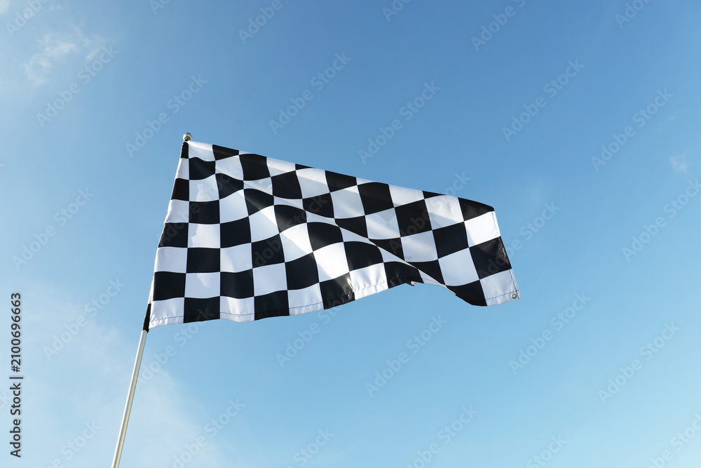 Obraz premium One checkered flag against blue sky outdoors, low angle view