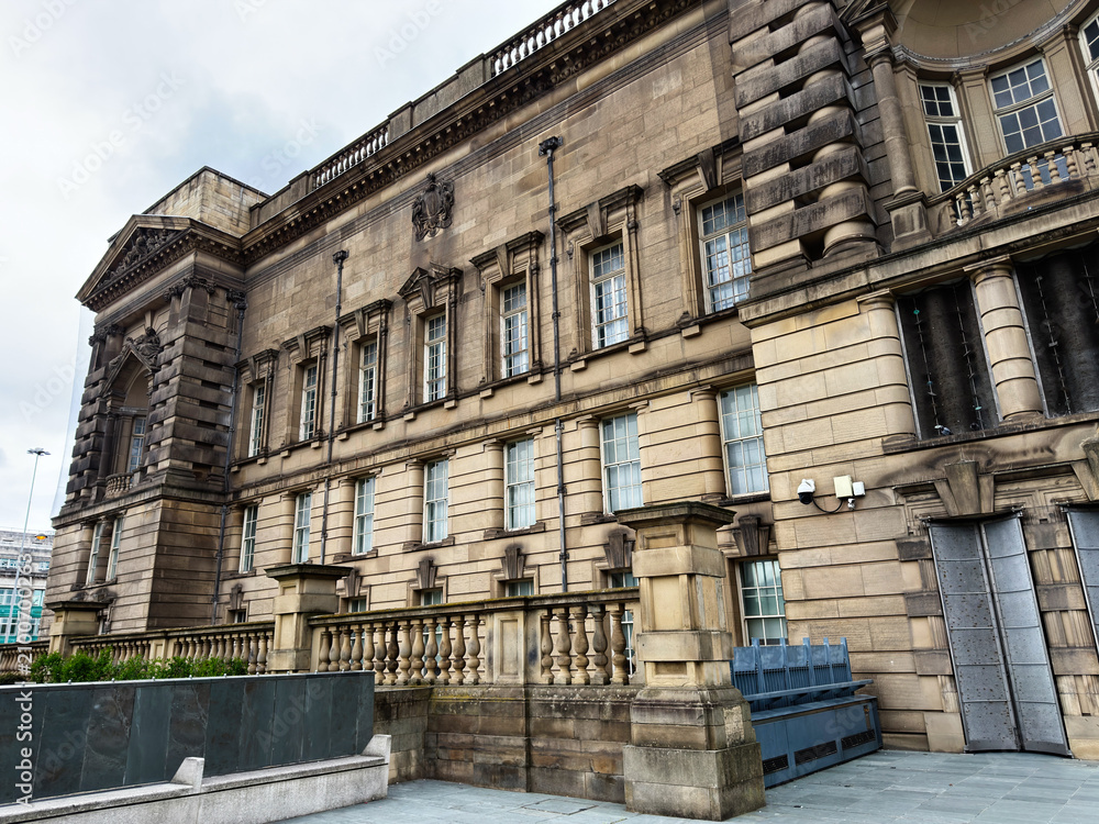 Obraz premium Historic stone municipal building facade in Liverpool, UK with neoclassical architecture, balustrade, sash windows and textured sandstone exterior as a civic landmark