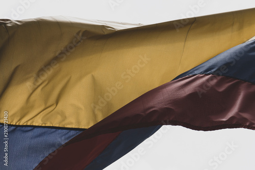 Bild auf Leinwand Colombia flag waving in a blue cloudy sky