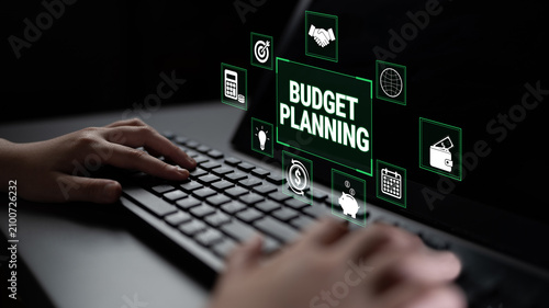 Canvastavla Hands Typing on Keyboard with Digital Icons Representing Budget Planning, Financial Management, and Business Strategy in Dark Environment Fluxor