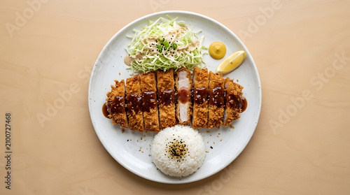 Golden crispy Korean pork cutlet sliced into even pieces and drizzled with rich brown sauce,