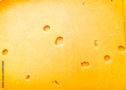 Bild auf Leinwand Macro texture of yellow cheese with holes, dairy product food pattern background