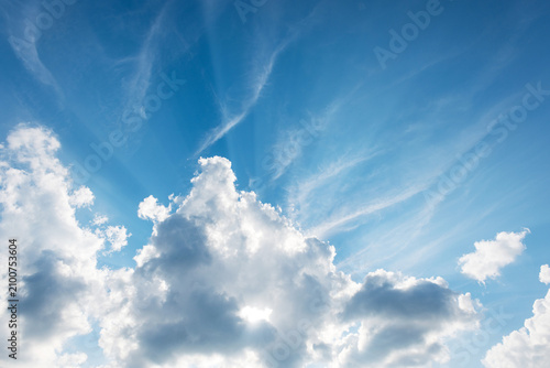 Photography Dramatic blue sky over fluffy cumulus clouds, streaked with delicate cirrus