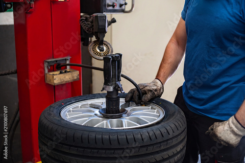 Cuadro en lienzo Auto mechanic operating a tire changer machine to mount or remove a car tire in a professional automotive workshop