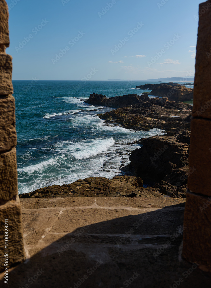 Fototapeta premium Ocean view from stone arch in Essaouira medina, Morocco overlooking rocky coastline