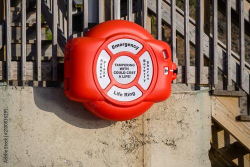 Red life ring secured to concrete wall
