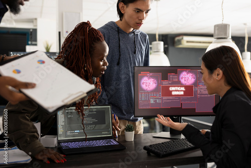 Tablou pe pânză Multiethnic team of developers working anxiously to resolve unexpected critical error on computer