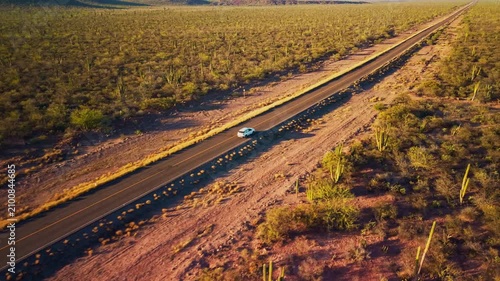Car driving through desertic landscape 