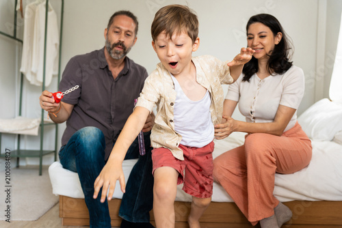 Photography Happy family with little son playing with soap bubbles at home, Joyful parents w
