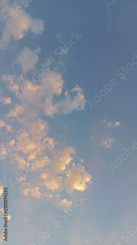 Canvas Print Vertical view of beautiful golden hour clouds on blue sky background at sunset o