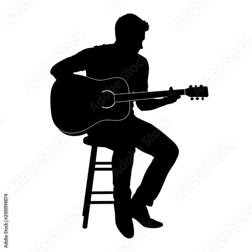 Man playing acoustic guitar on stool silhouette