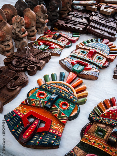 Obraz na płótnie Colorful handcrafted wooden tribal masks displayed at the famous Otavalo Market in Ecuador