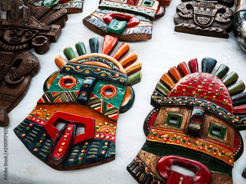 Fotografie Colorful handcrafted wooden tribal masks displayed at the famous Otavalo Market in Ecuador