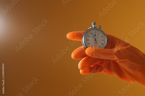 Hand in orange rubber glove...