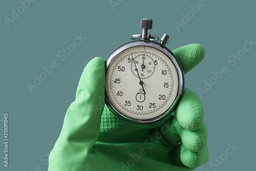 Hand in green rubber glove ...