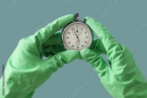 Hands in green protective g...