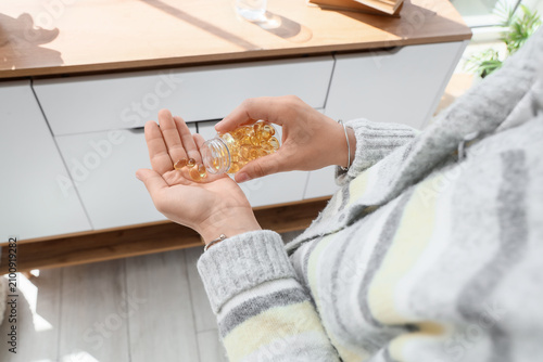 Woman pouring yellow omega ...