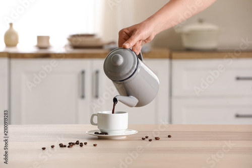 Hand pouring fresh hot coff...