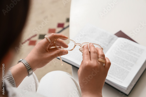 Person cleaning eyeglasses ...