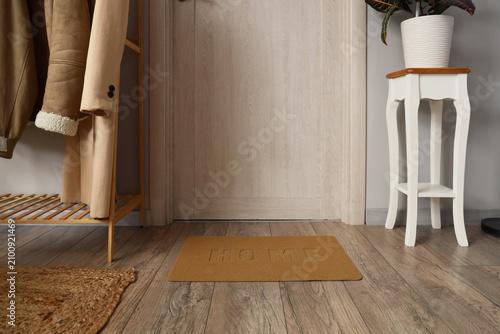 Door mat on wooden floor in...