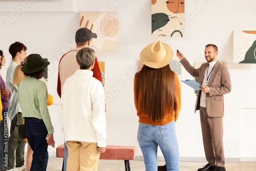 Male guide showing painting...