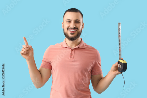 Young man with measuring ta...