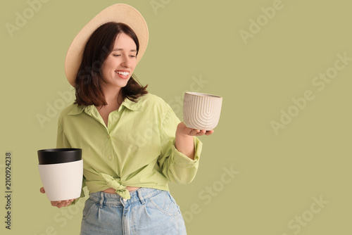 Young woman with plant pots...