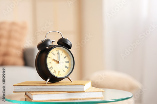 Alarm clock with books on g...